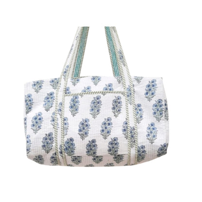White Duffle bag with blue floral pattern on a white background
