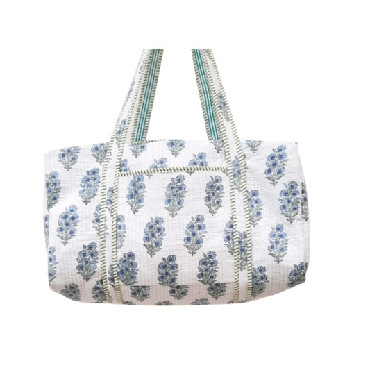 White Duffle bag with blue floral pattern on a white background