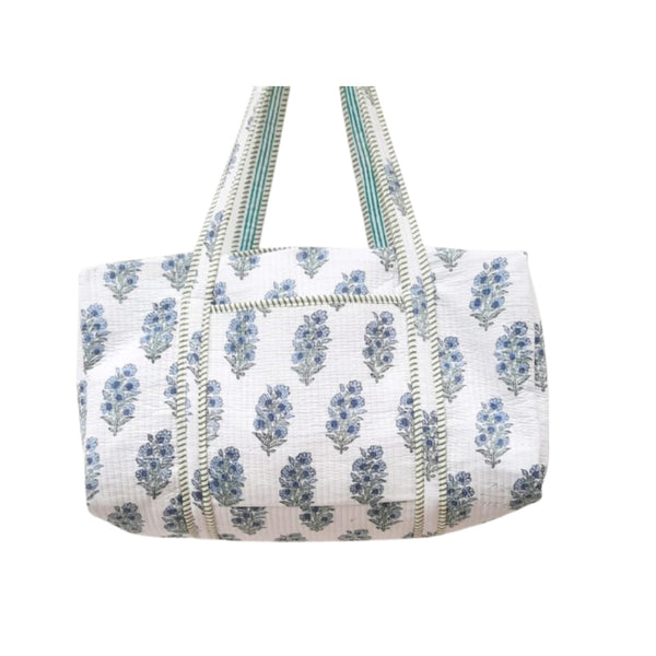 White Duffle bag with blue floral pattern on a white background
